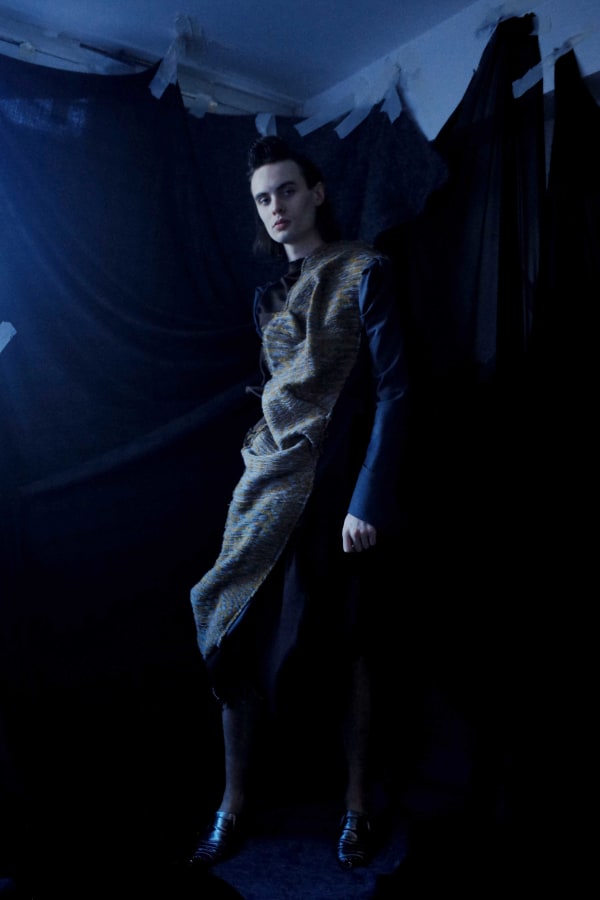 Figure wearing dark garments