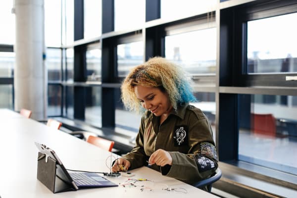a student experimenting with technology hardware