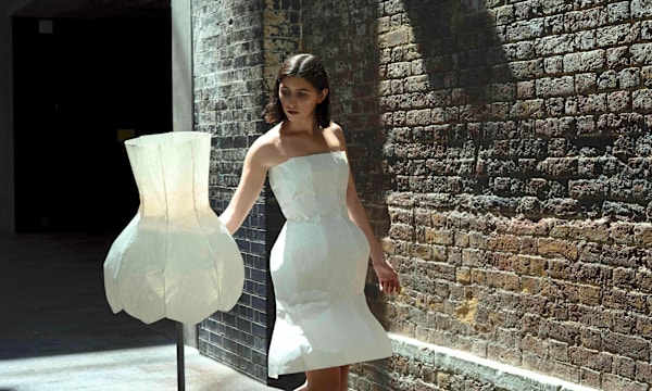 A person dressed in a lamp shade at Central Saint Martins fashion university