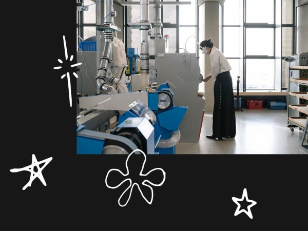 Student working on large machinery in workshop