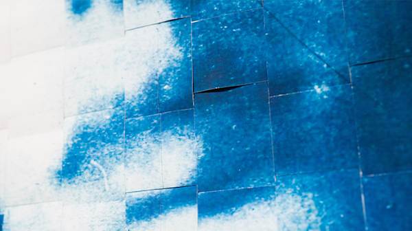 Close up of lips in blue and white on cut out paper squares