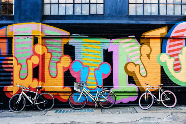 Bikes against a graffiti wall near London College of Fashion