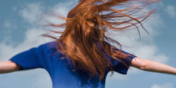 Photograph of a girl with her hair blowing in the wind