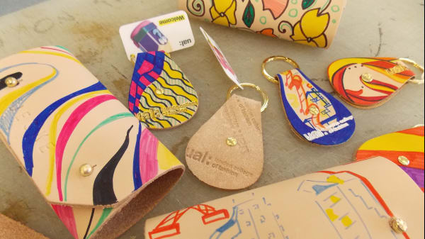 Close-up of cork and leather keyring-making workshop.