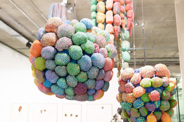An Installation with stuffed balloon like elements hanging from the ceiling