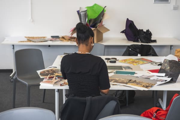 Person sat at table working with back to camera