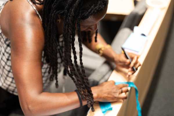 Person with pen in hand, creating 