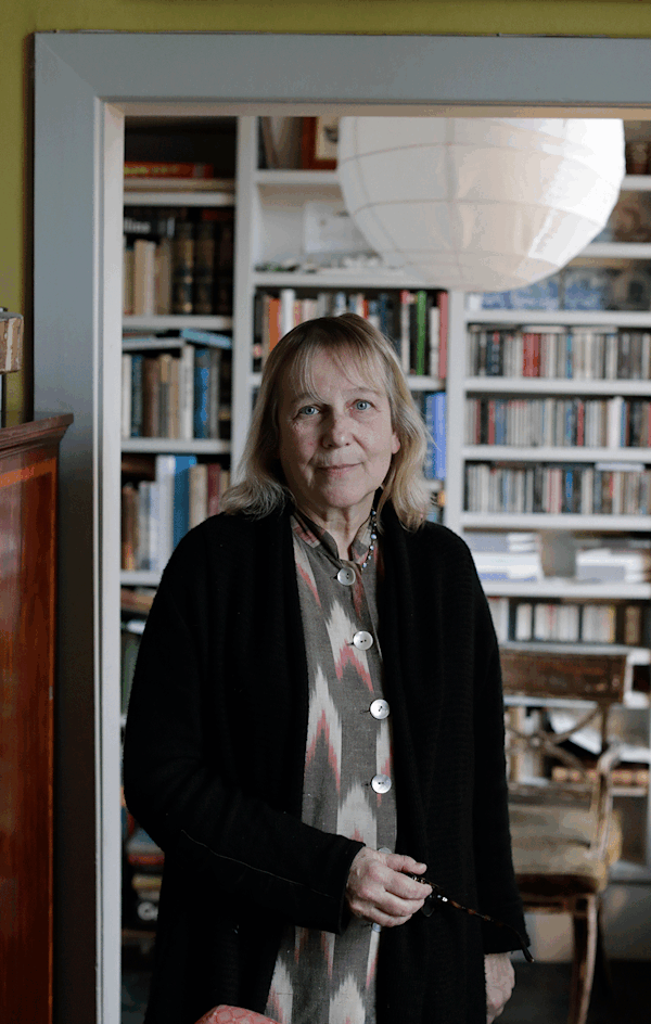 Woman standing in front of bookcase