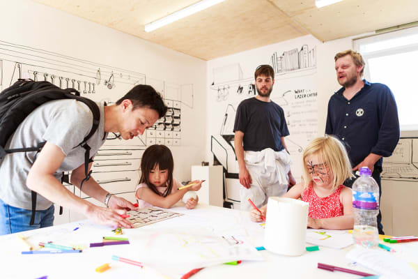 Adults and children working together on a project