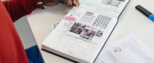 Student working with their notebook with working materials around them