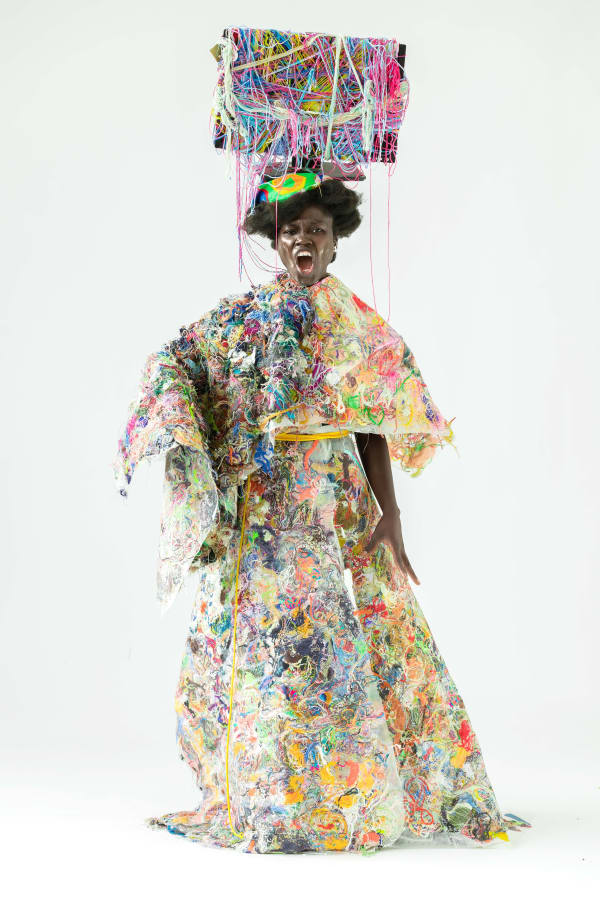 Aramatou Toure, BA Textile Design graduate, wears a garment produced for her final project
