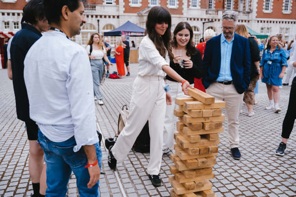 People outdoors playing a game of Jenga, Photographed by UAL.