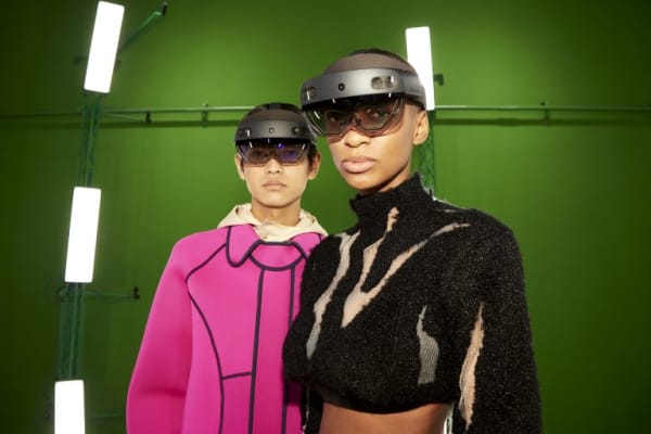 Two people in mixed-reality headsets