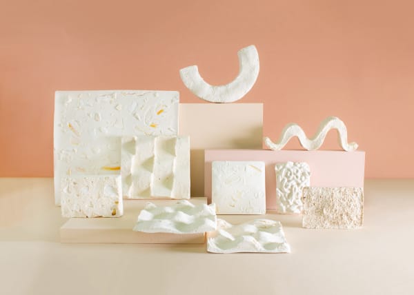 a presentation of small white and textured sculptures in different shapes