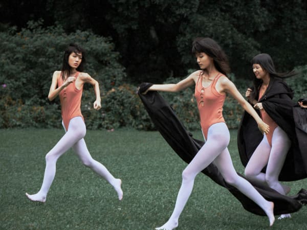 Dancers outside wearing leotards.