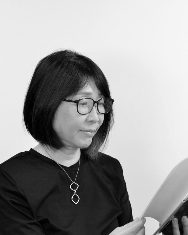 A black and white head and shoulders shot from the side