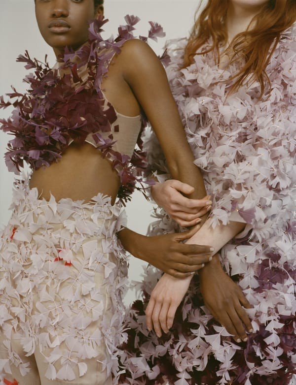 High fashion image of models wearing garments out of feathers