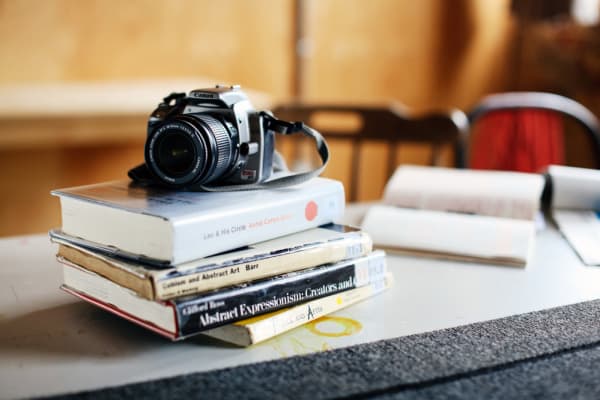 Camera on a stack of books, BA (Hons) Culture, Criticism and Curation, Working resources of Rebecca Derine, Case study, Copyright holder: Alys Tomlinson