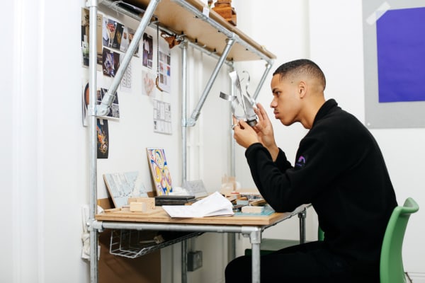 Student sat at a desk in the studio