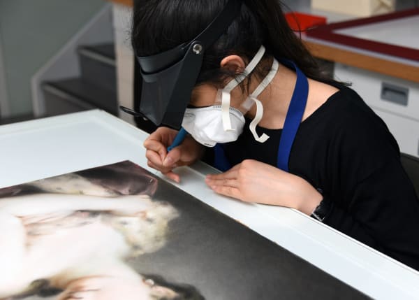 Woman in a face mask working on a painting