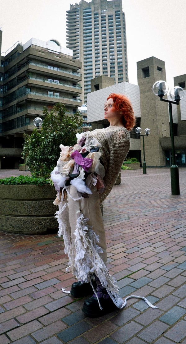 Woman with bright red hair wearing heavily embellished dress