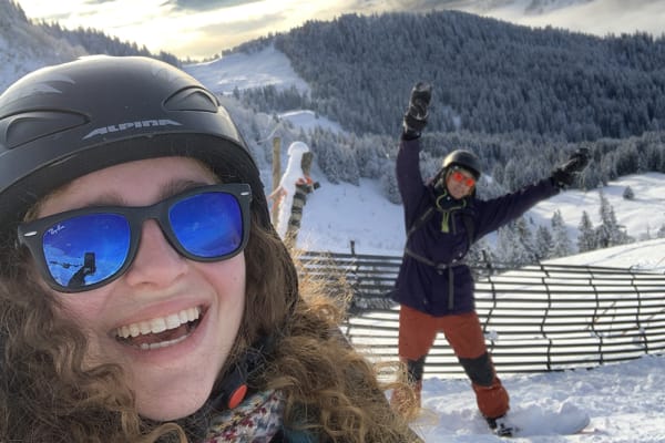 Two students smiling on a ski slope