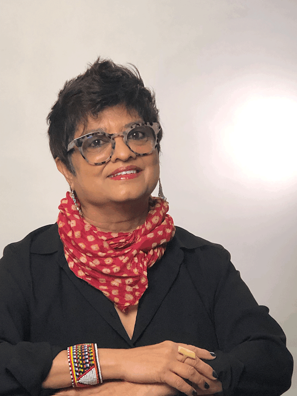 Woman smiling with folded arms and red neckscarf
