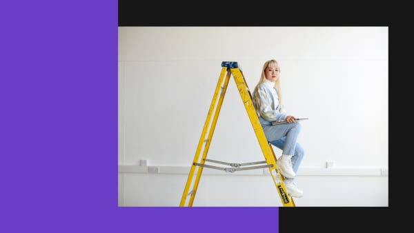 Student posing on a ladder