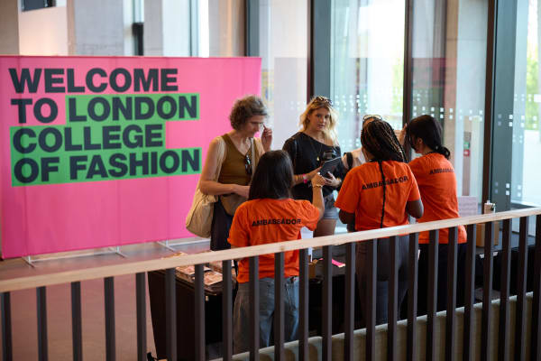 Two female visitors being greeted by LCF ambassadors during an Open Day