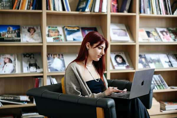 Student using a laptop in the library.