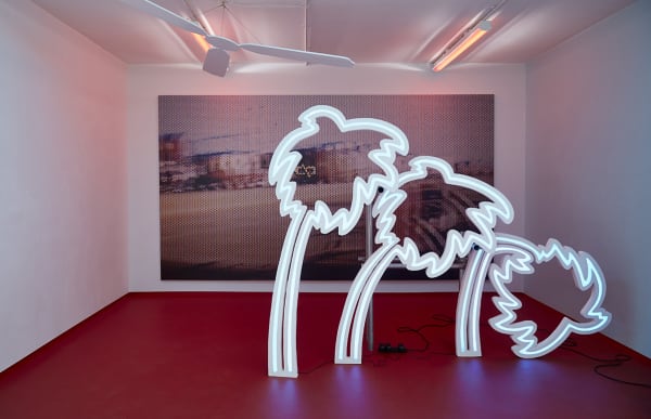 Installation with large scale photographic print and neon lit palm trees with red floor. By Sarah Entwhistle - Chelsea BA Fine Art.