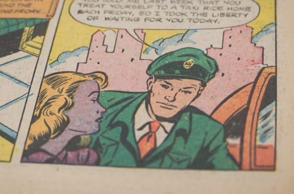 Close-up of a comic book, showing a man and woman interacting