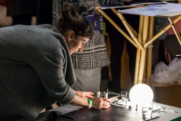 Woman placing object besides a circular lightbulb, MA Applied Imagination in the Creative Industries, Applied Imagination Festival 2017, Culture and Enterprise Programme, © Jolly Thompson