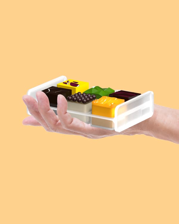 A hand holdin a tray of food on an orange background