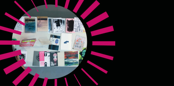 picture of zines inside a pink graphic radial circle on a black background