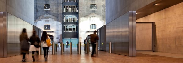 Interior shot of Central Saint Martins. Students entering and exiting the building.