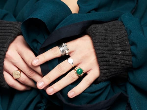 Close up of hands wearing stackable rings.