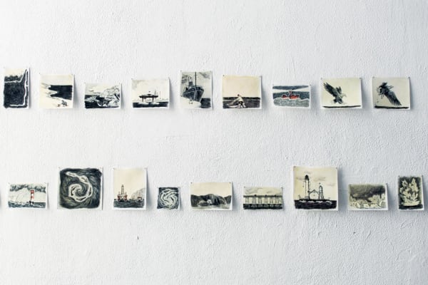 Image showing a curation of black and white photographies on a white wall