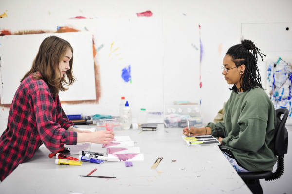 Two students in the art and design studio