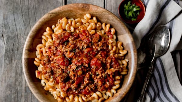 Birdseye photograph of a bowl of pasta and sauce 