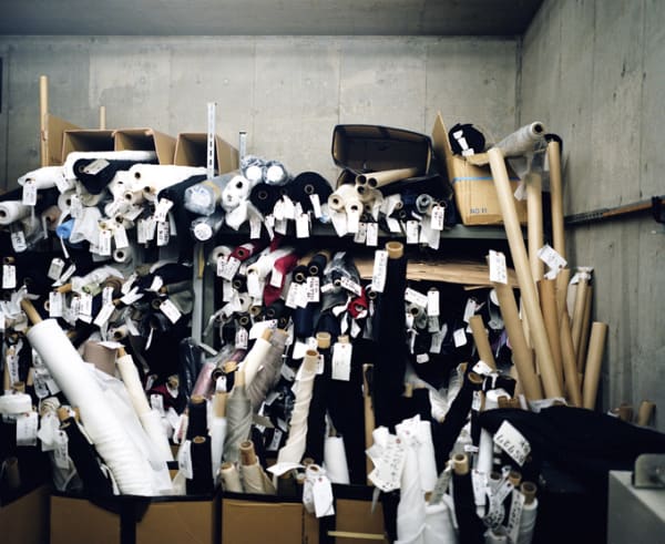 photo of a studio storage space filled with rolls of fabric.