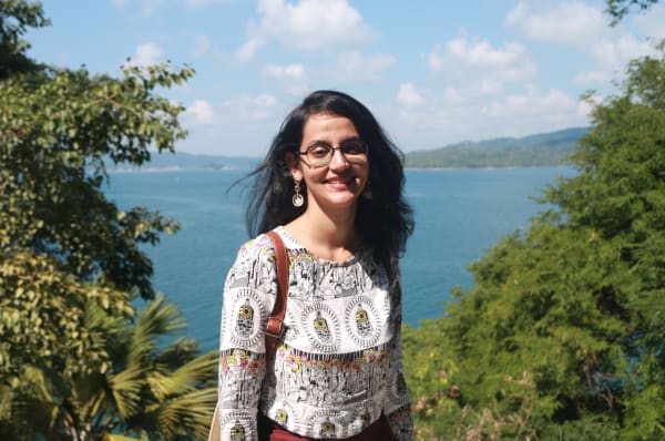 Image of UAL student Trisha Rathod in front of a sea view