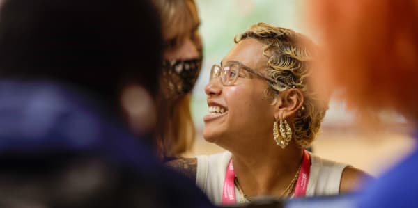 student in a crowd smiling