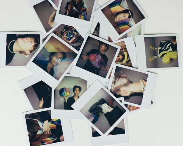 Collection of Polaroid photographs scattered across white table