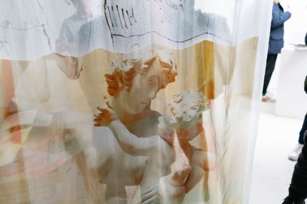 A sheer screen curtain featuring a Greek statue bust