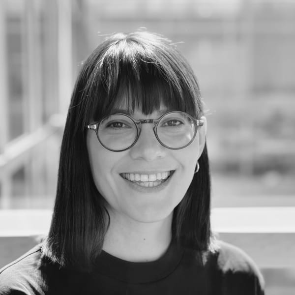 Natalie Nestorowicz, a white woman with brown eyes and straight, medium length brown hair smiling at the camera