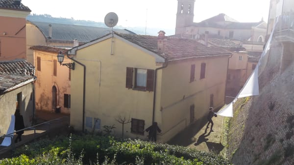View of a yellow house with children playing outside