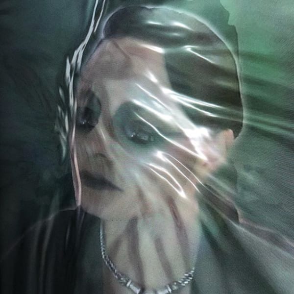 distorted image of model behind plastic wrap, face pressed up against the plastic - creating dimension. Model wears a metallic necklace, and black garment. In front of a green background.