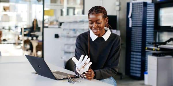 Student wearing a white computational glove