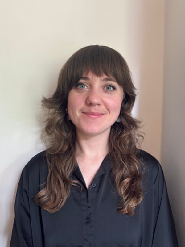 Person standing against a  grey background